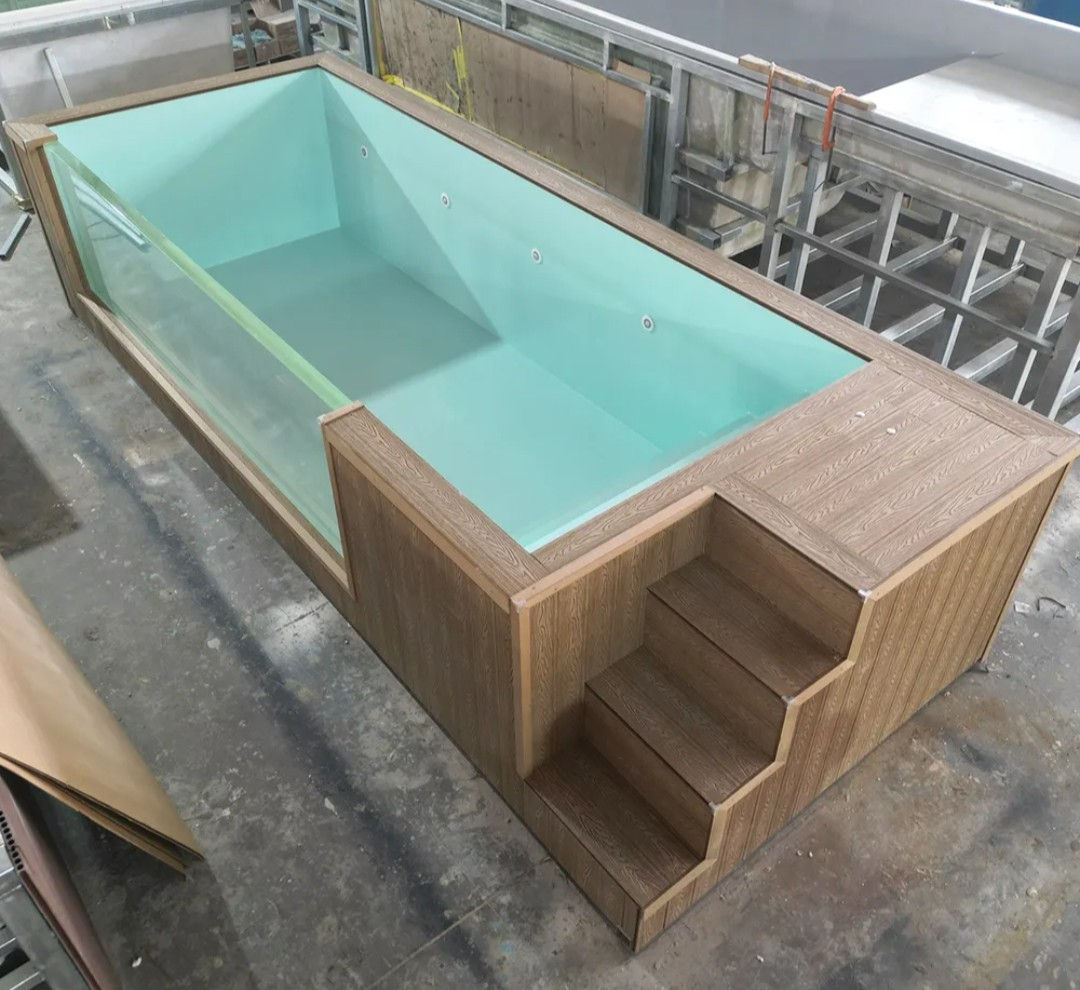 A plunge shell on the factory floor with wood-look cladding and steps.