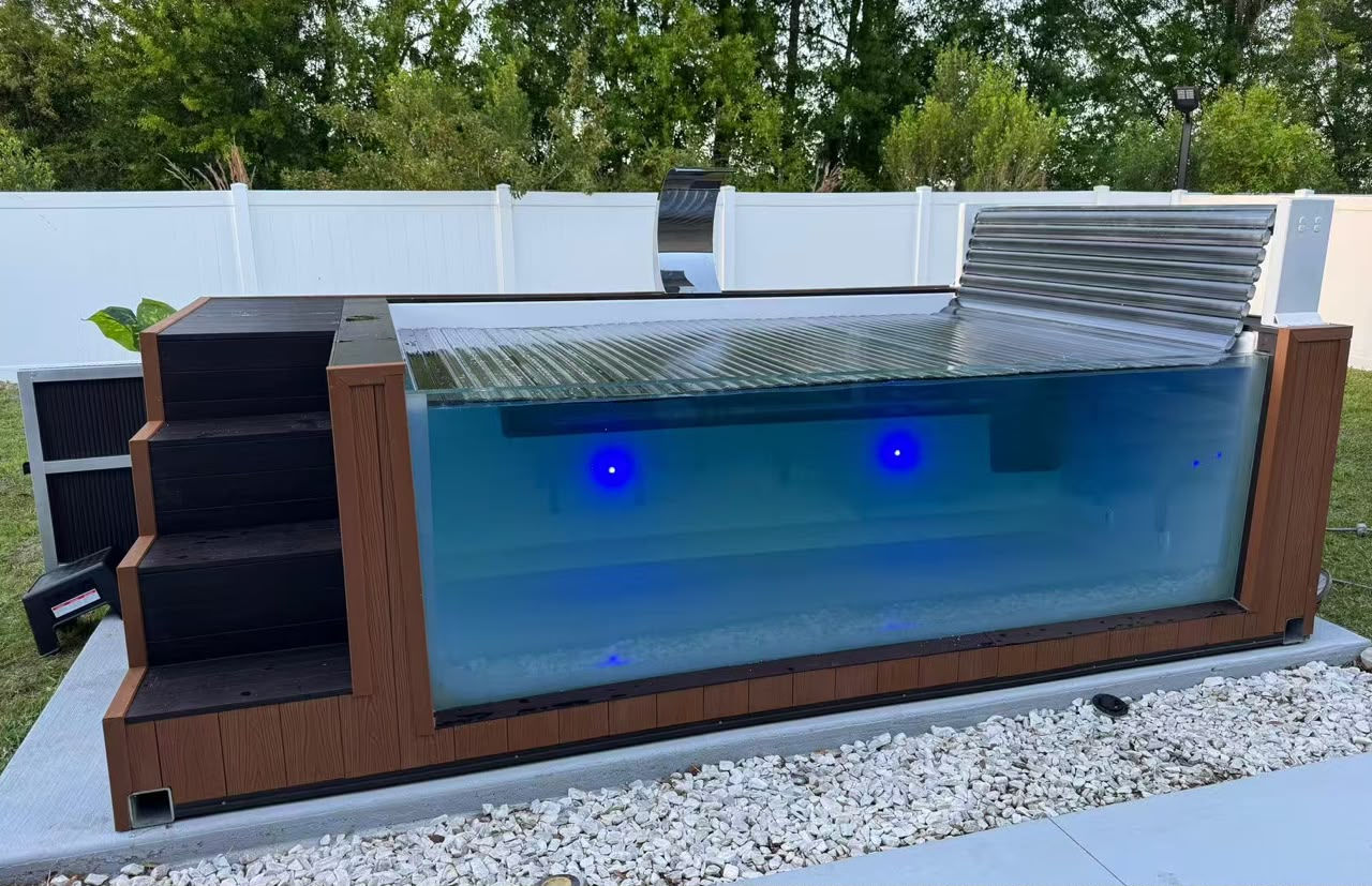 A wood-clad plunge pool with the cover half open.